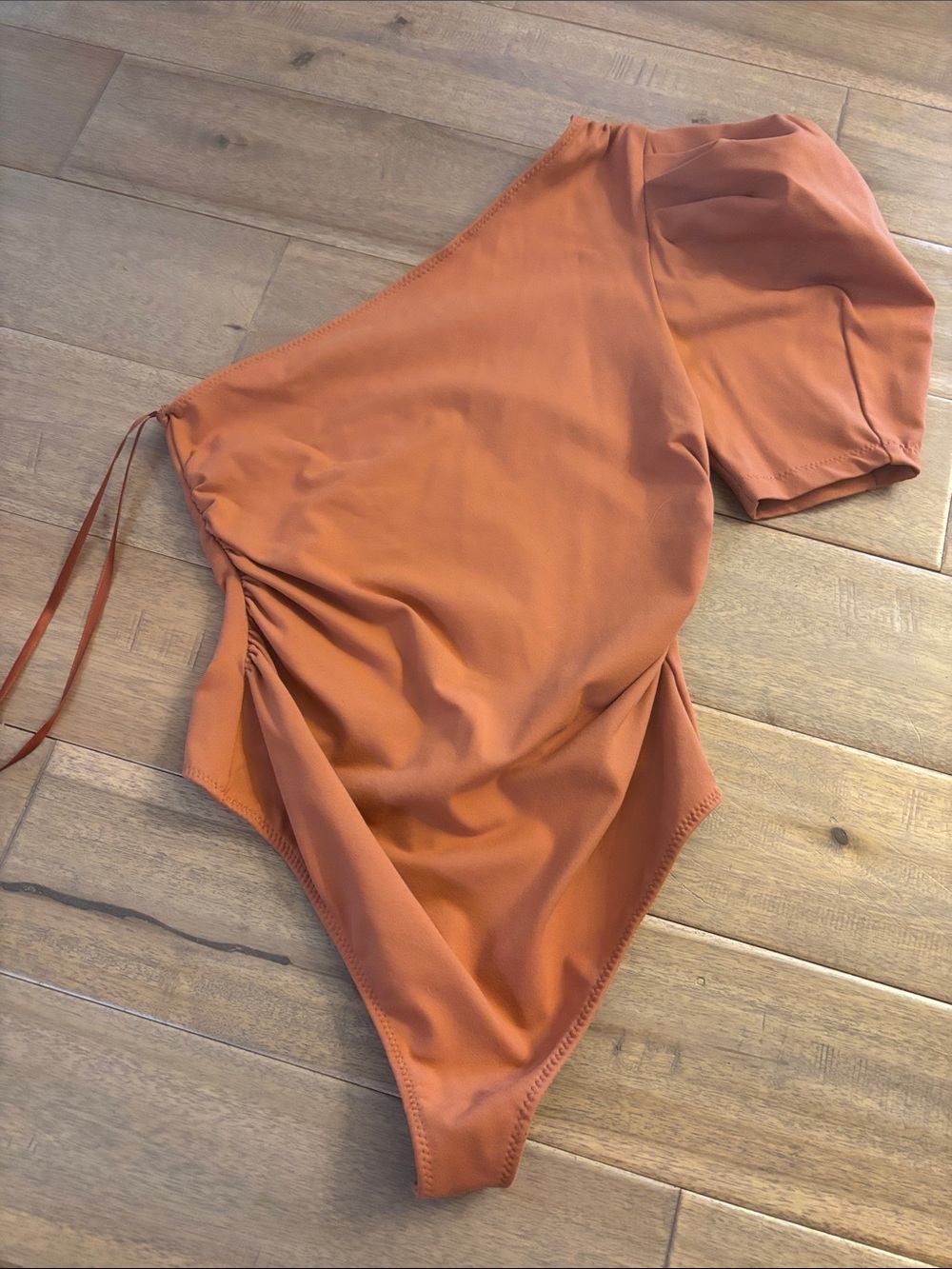 Free People Asymmetrical One-Shoulder Bodysuit in Rust